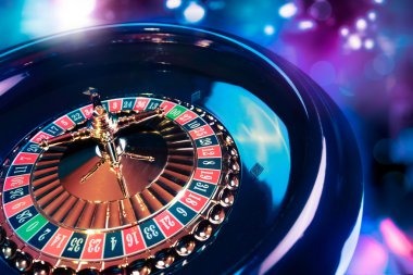 Roulette wheel with betting chips on numbered layout during active game